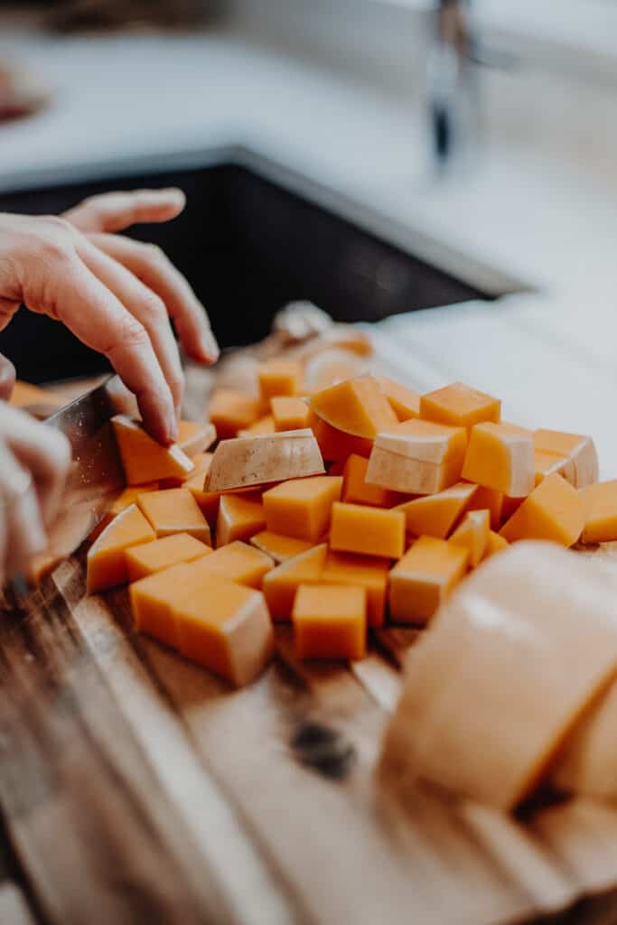 Chopping up a butternut squash.