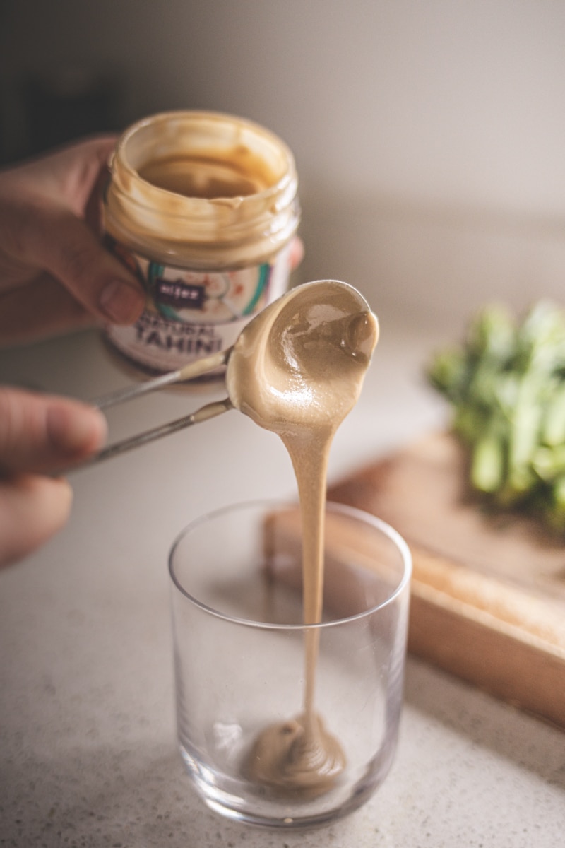 measuring tahini into a glass