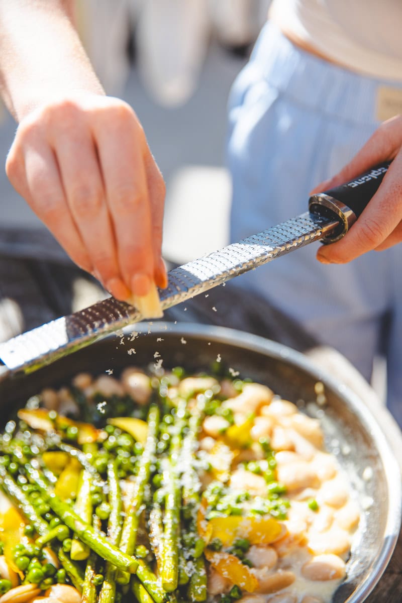 Grating parmesan on Beans al Limone with Asparagus & Peas - Georgie Eats